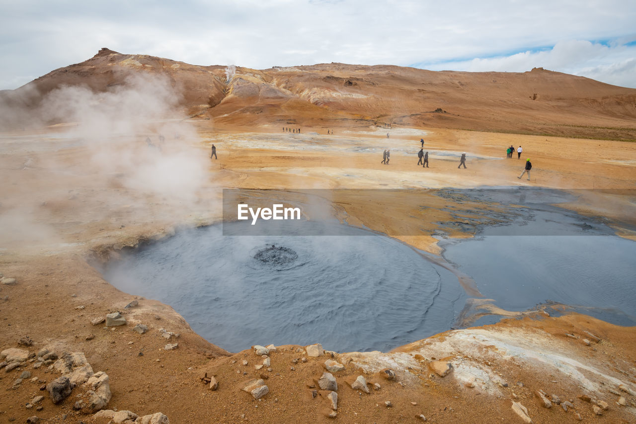 Scenic view of geyser against sky