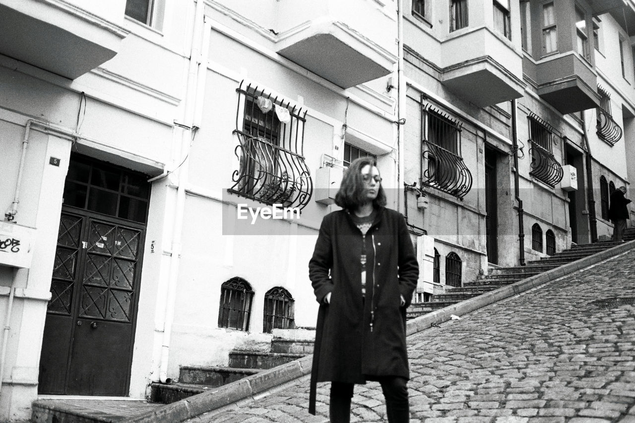 MAN STANDING IN CITY