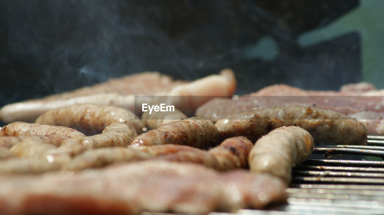 CLOSE-UP OF MEAT ON BARBECUE