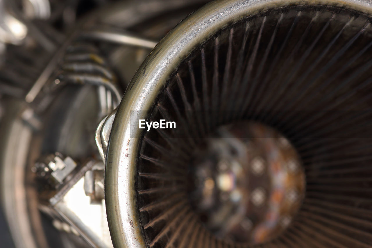 aircraft engine, metal, close-up, wheel, machine part, machinery, engine, equipment, no people, technology, indoors, transportation, gear, selective focus, jet engine, spoke, industry, extreme close-up