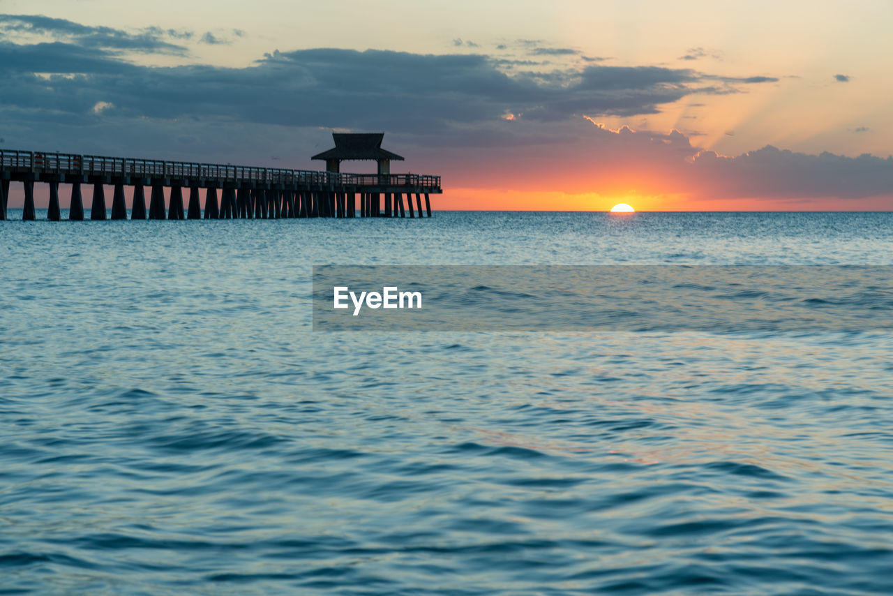 Naple pier at sunset and ocean