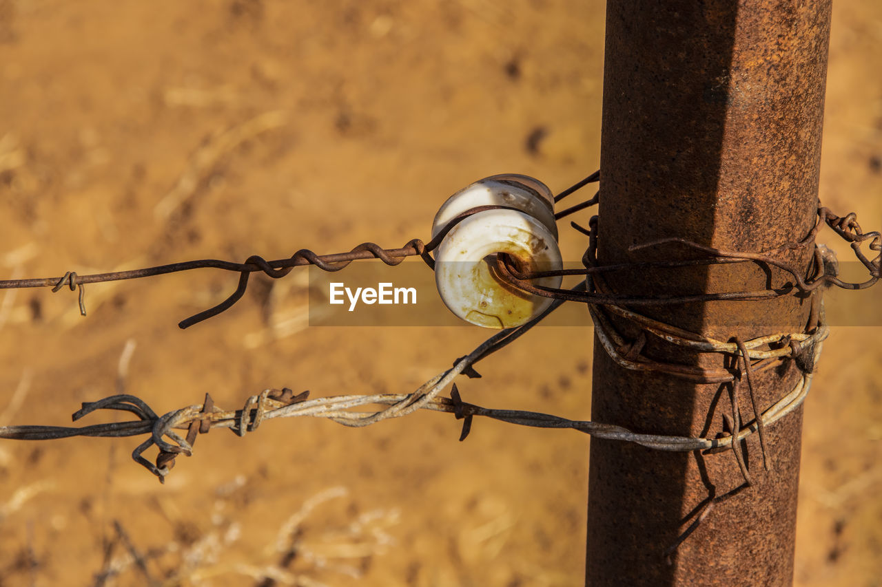 CLOSE-UP OF BARBED WIRE FENCE