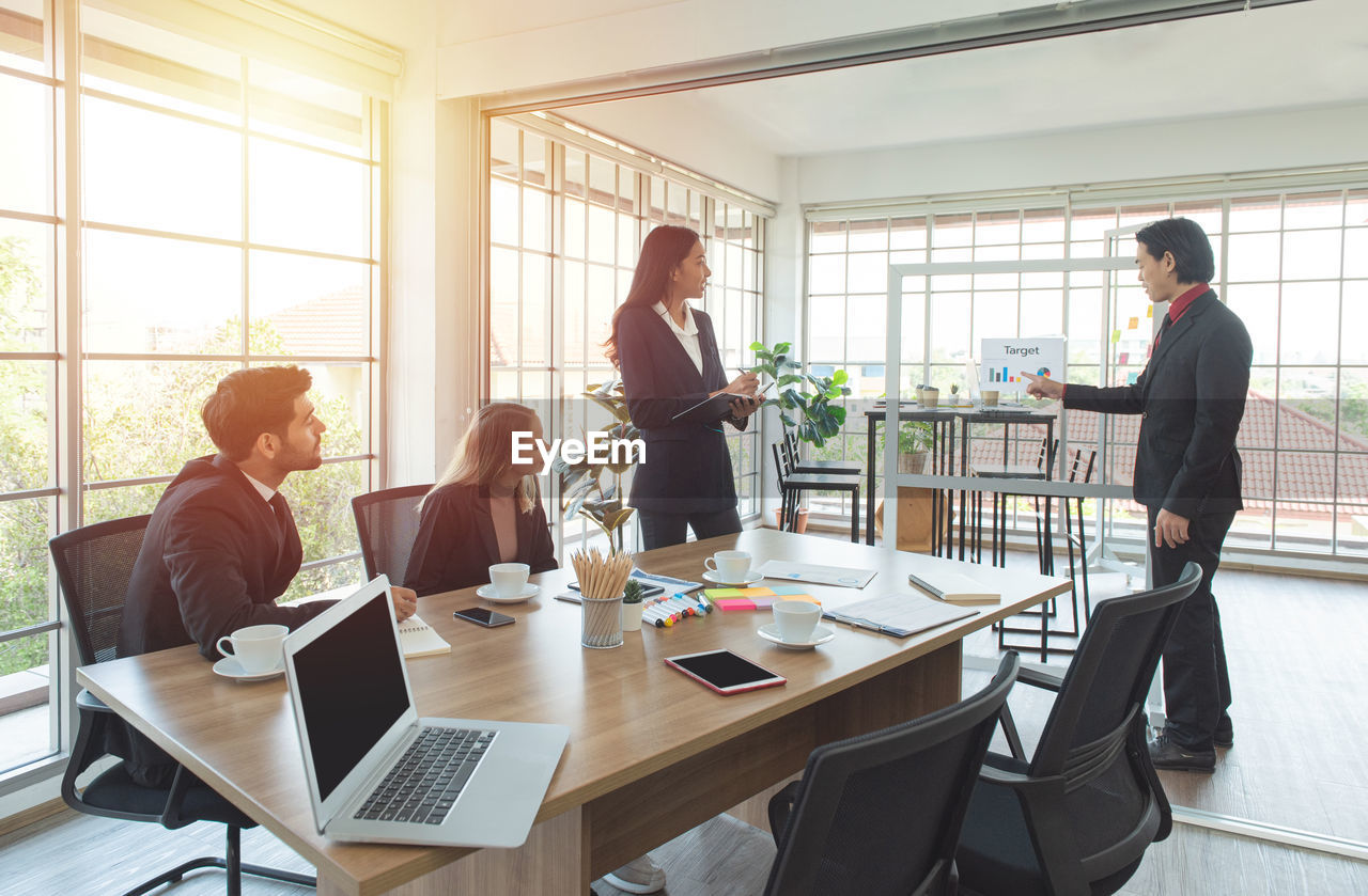 Cheerful businessman giving presentation in office