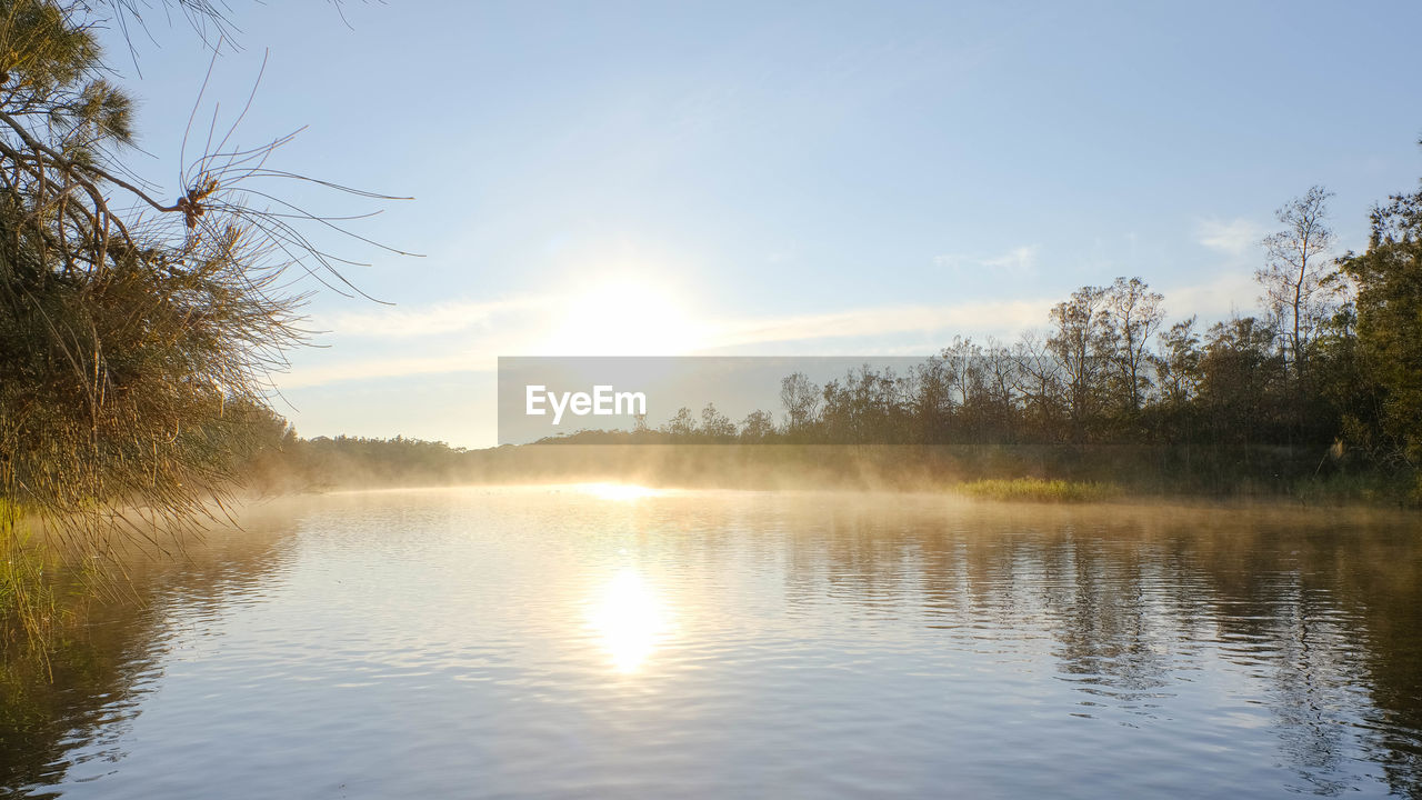 VIEW OF LAKE AGAINST SKY DURING SUNSET