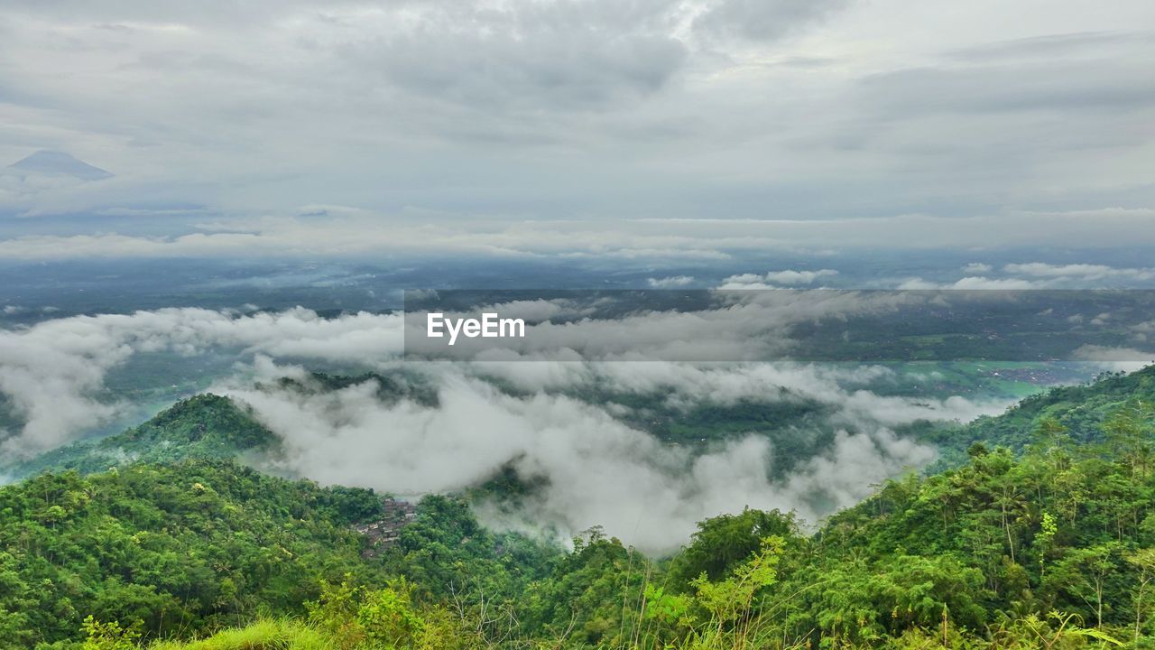 Beautiful views of hills and thick fog, against a background of white clouds