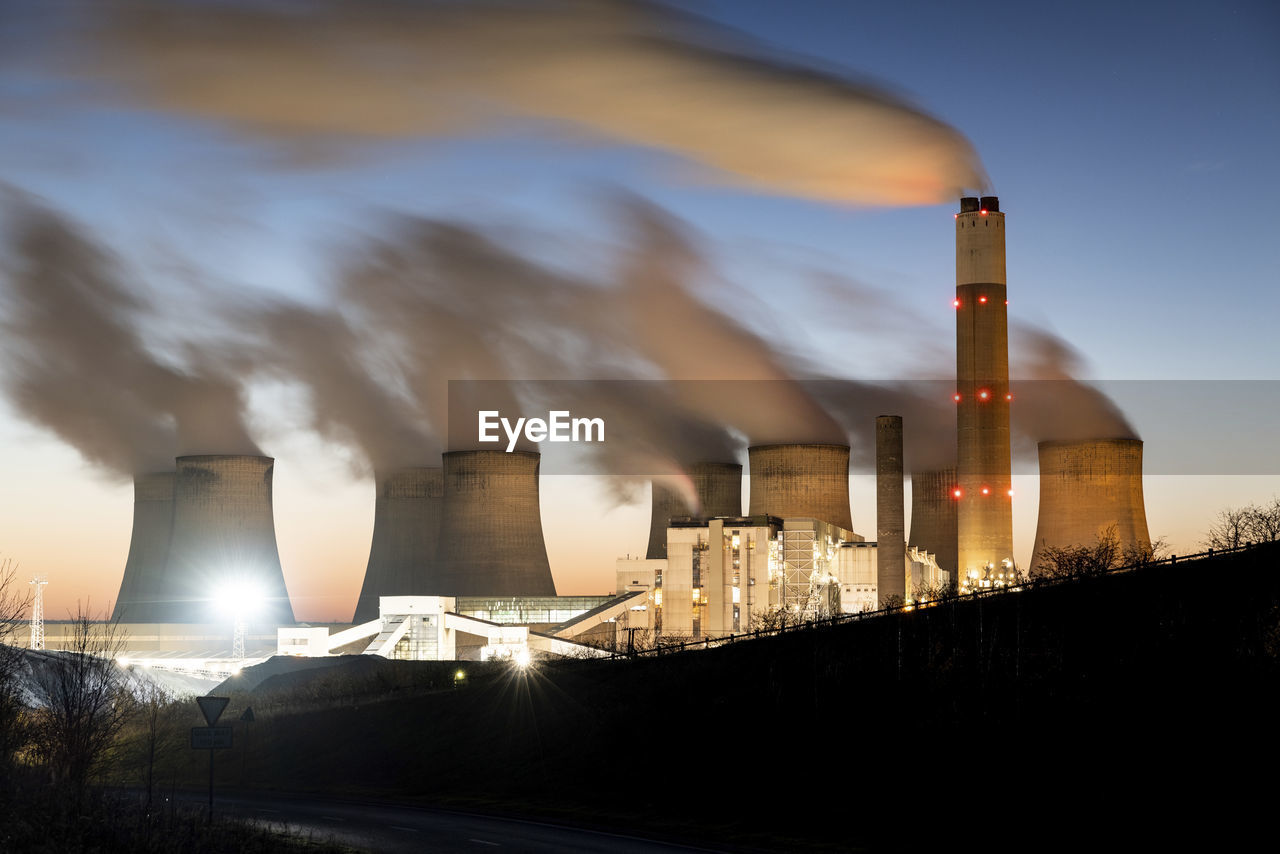Uk, england, nottingham, long exposure of water vapor rising from cooling towers of coal-fired power station at dusk