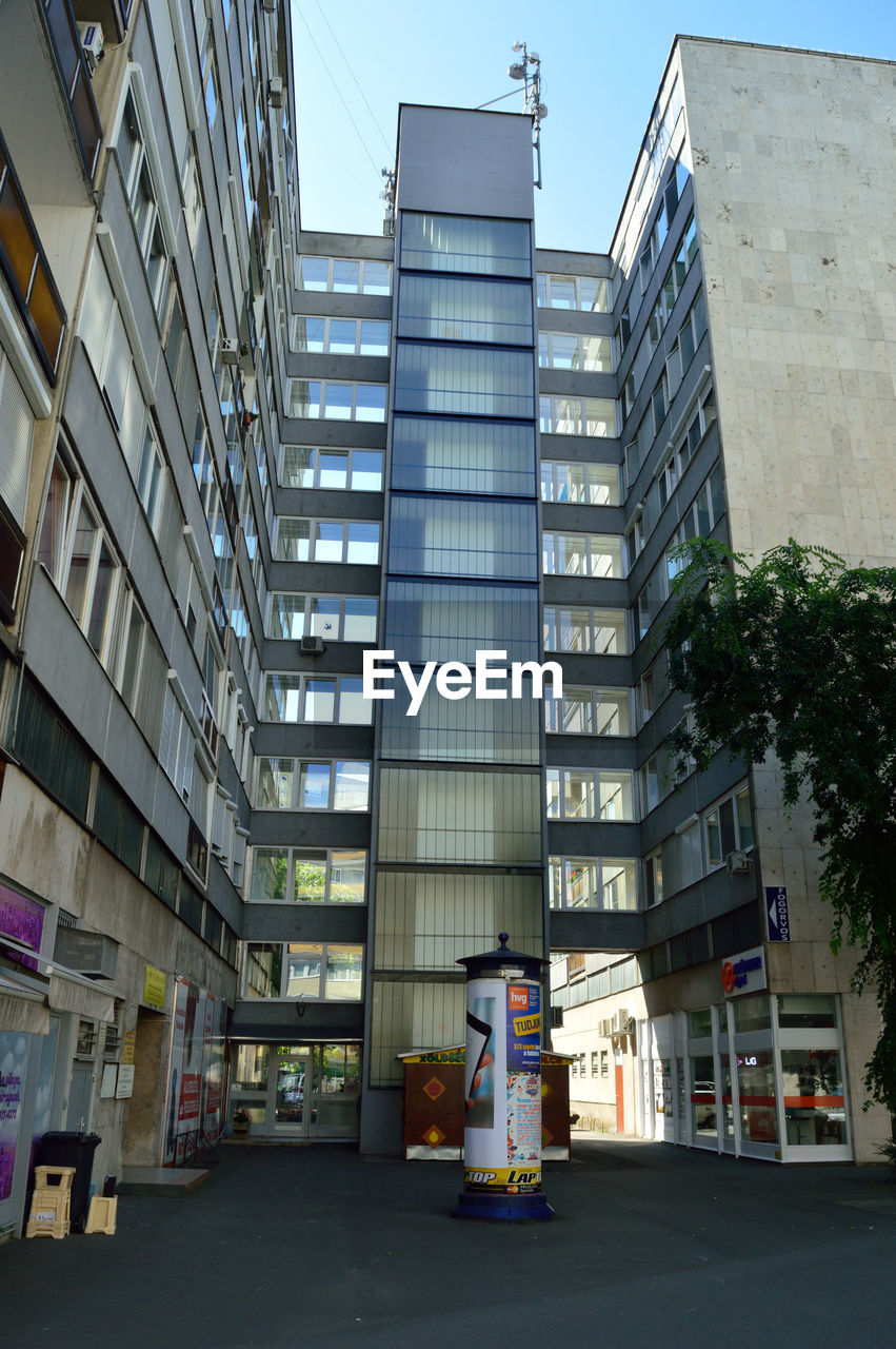 MODERN OFFICE BUILDINGS AGAINST SKY IN CITY