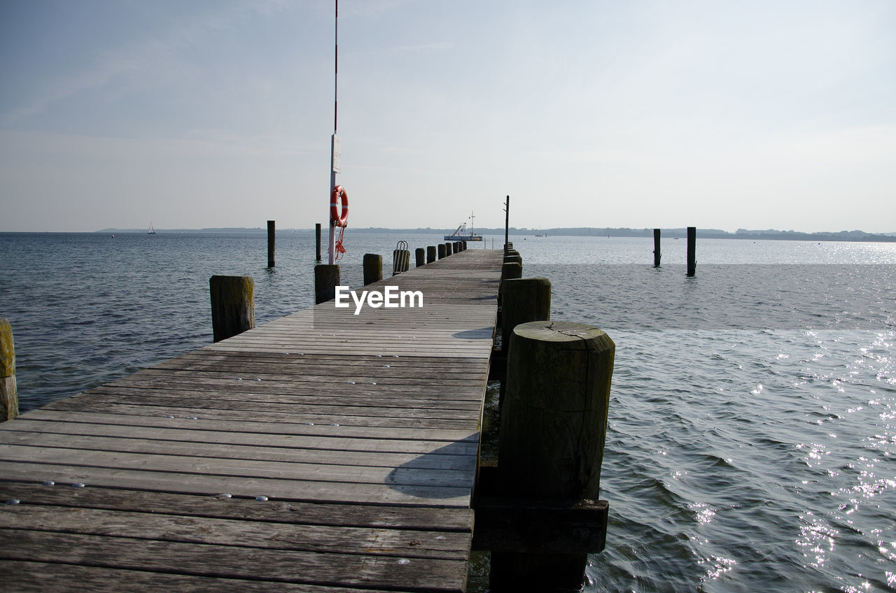 Pier over sea against sky