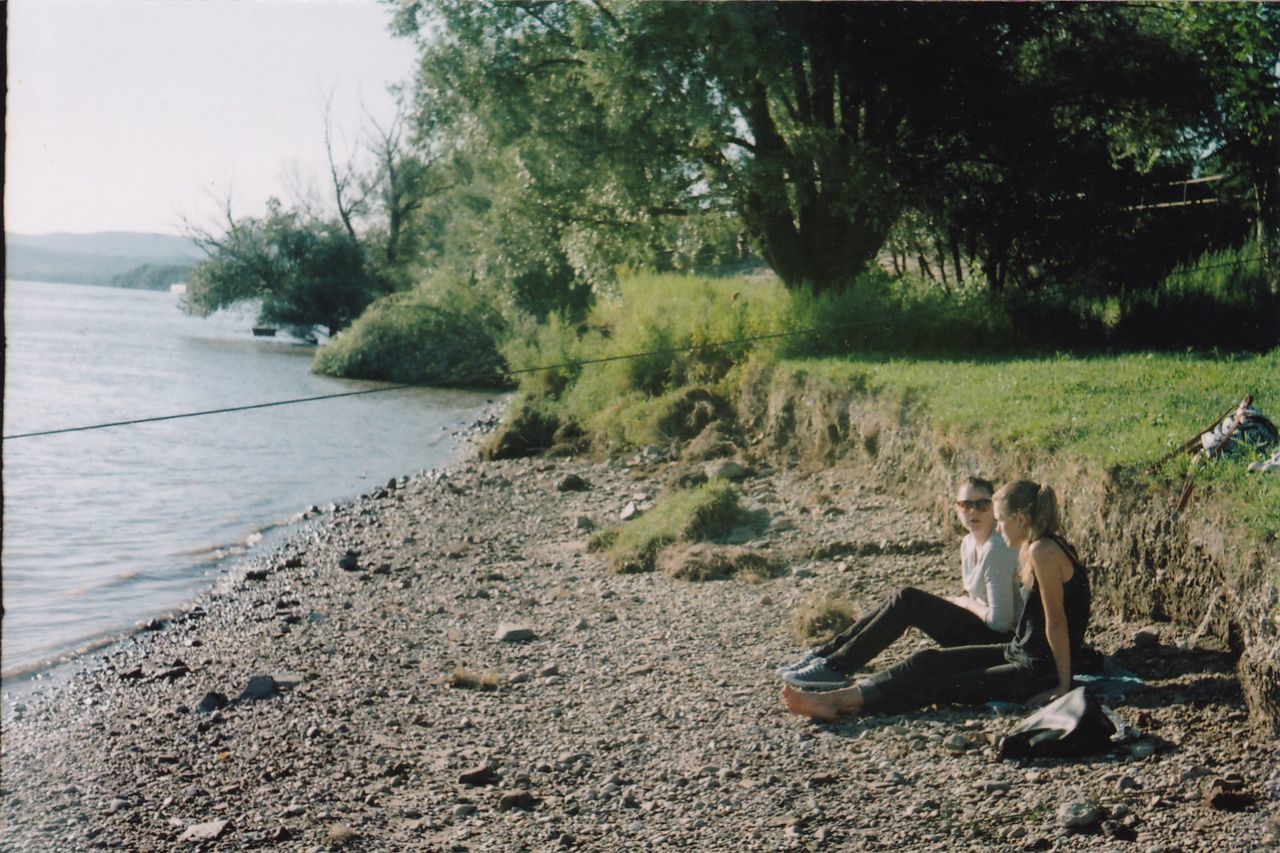 Woman sitting by lake