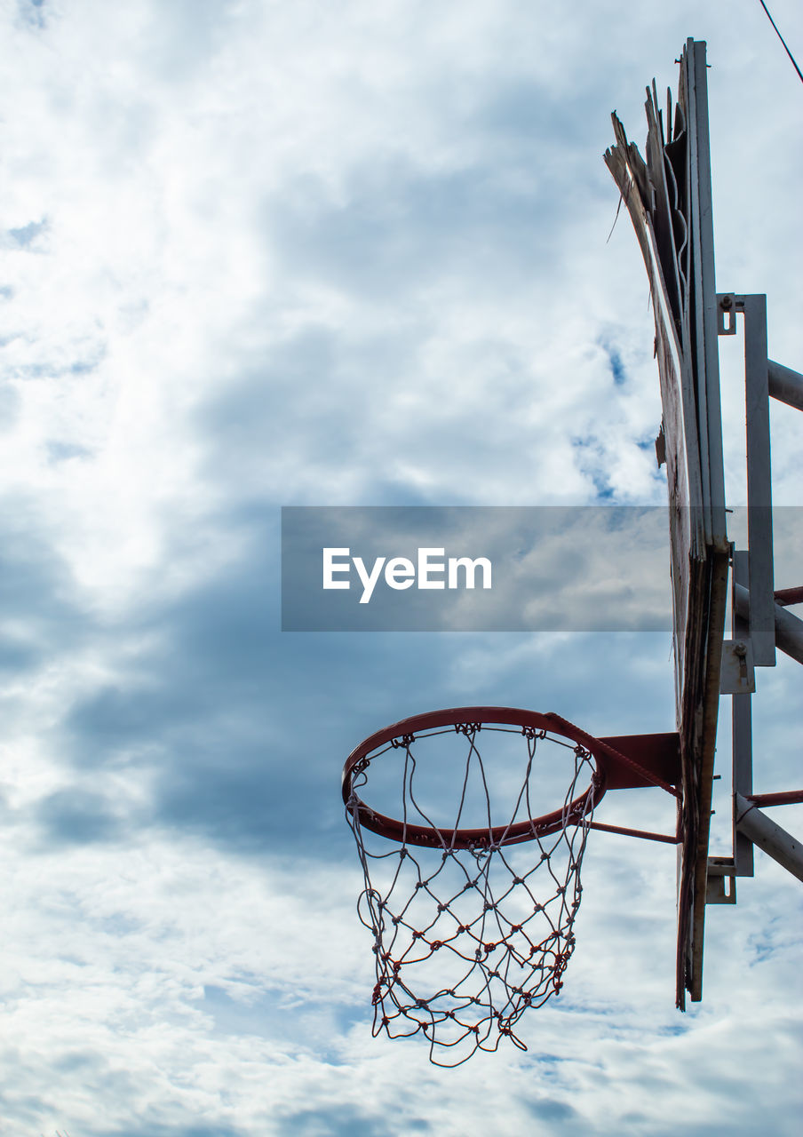 LOW ANGLE VIEW OF BASKETBALL AGAINST SKY