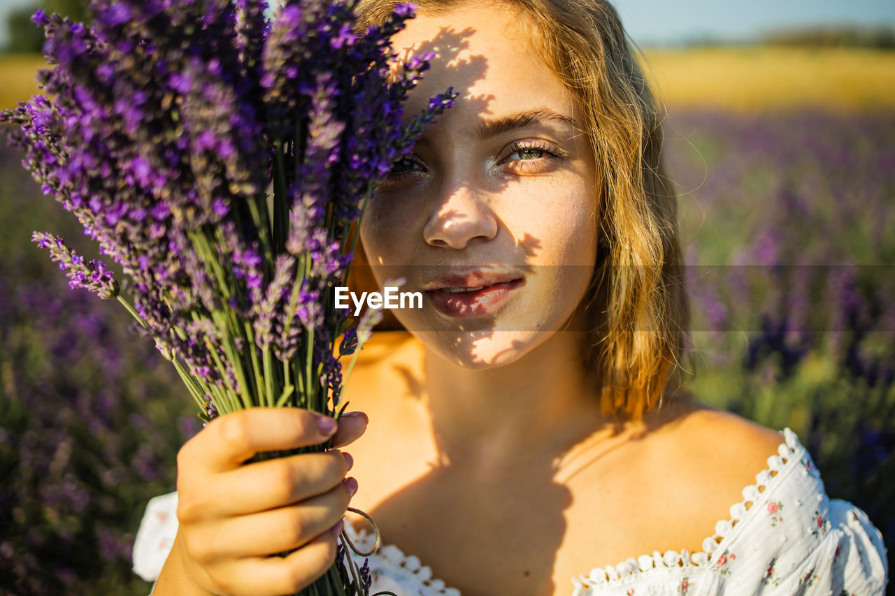 Portrait of young woman with lavender flowers