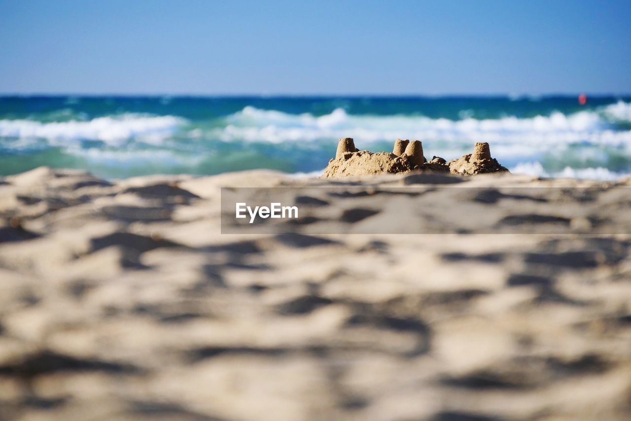 Close-up of if sand castle on beach