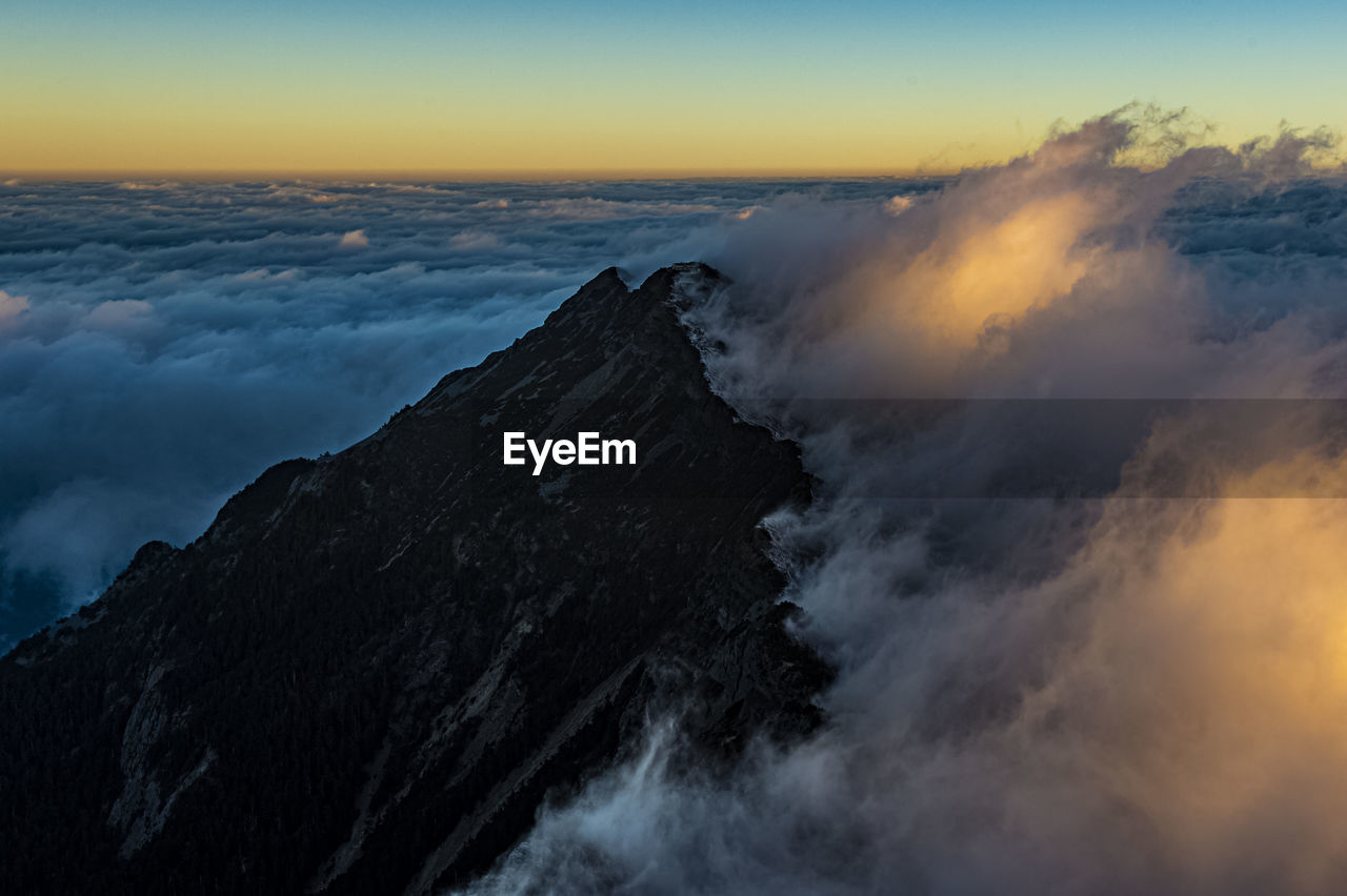 Scenic view of mountains against sky during sunset