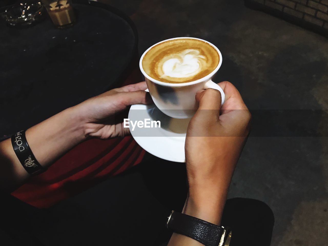 Midsection of person holding coffee cup