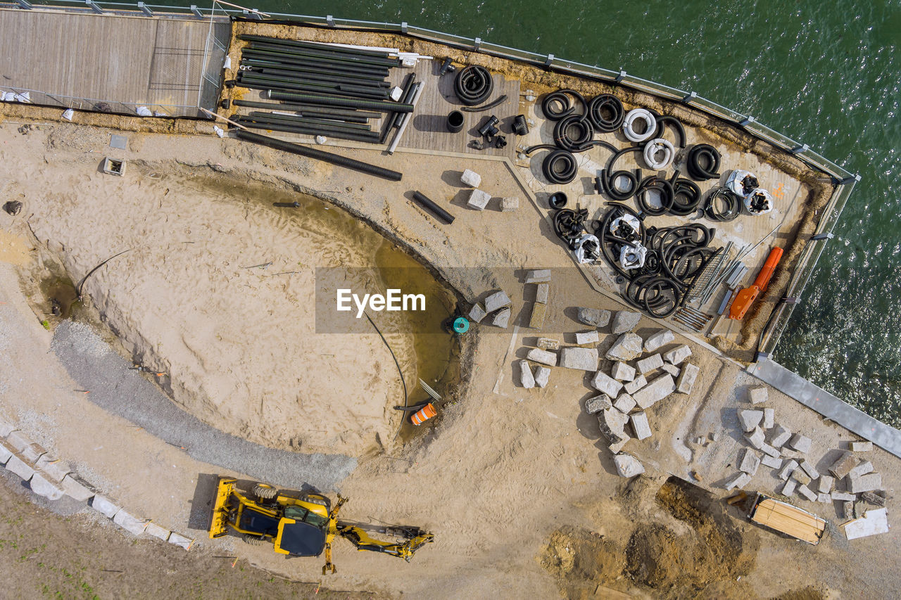 HIGH ANGLE VIEW OF CONSTRUCTION SITE AT ROAD