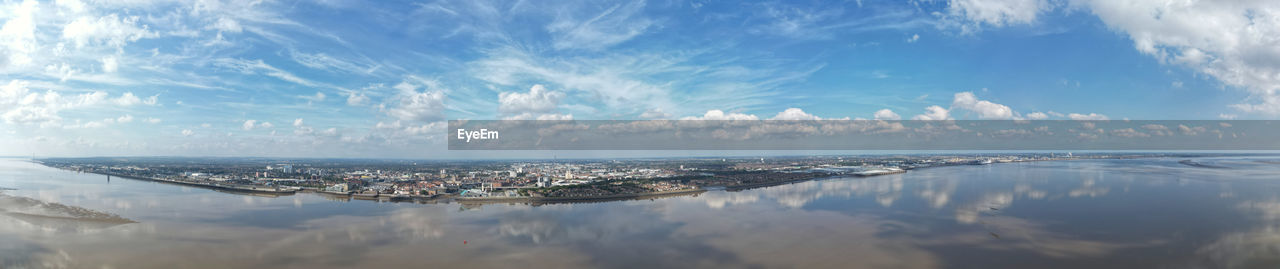 reflection, water, sky, cloud, horizon, panoramic, nature, sea, architecture, scenics - nature, city, morning, blue, no people, landscape, environment, outdoors, sunlight, travel destinations, beauty in nature, built structure, day, building exterior, tranquility, travel, coast, building, ocean, dusk, shore, wave