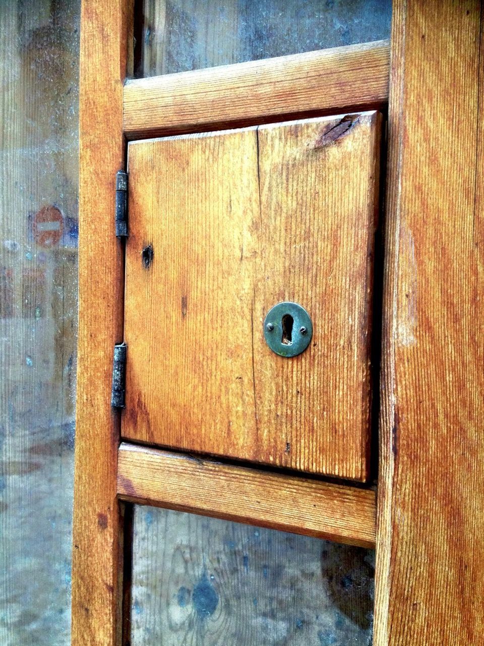 Close up of small wooden door with key hole