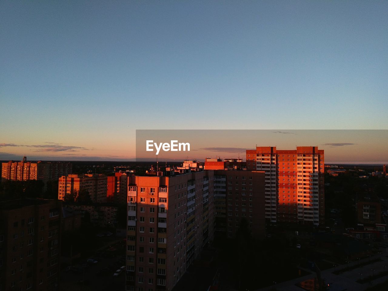 CITY BUILDINGS AGAINST SKY DURING SUNSET