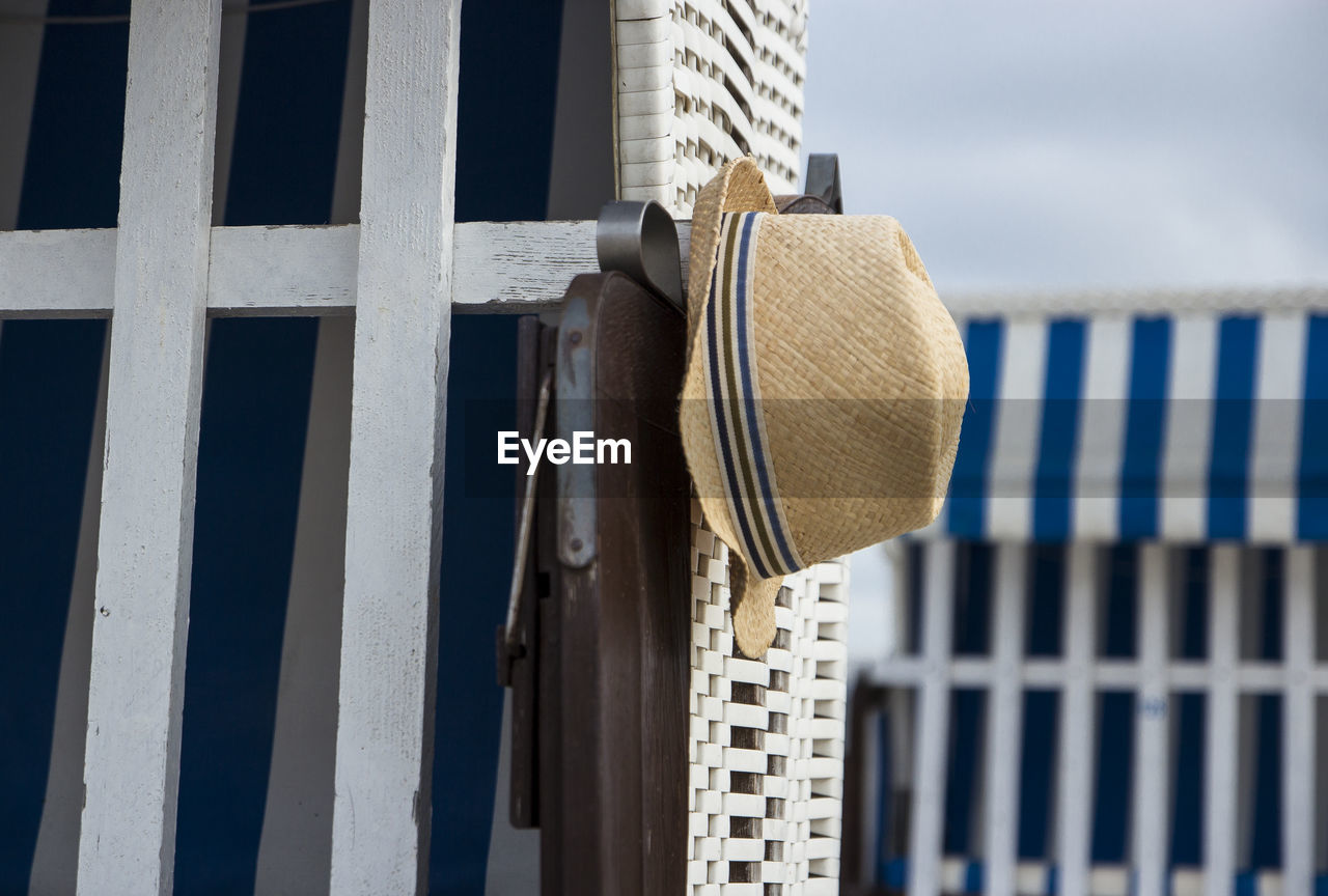 Close-up of clothes hanging on beach chair 