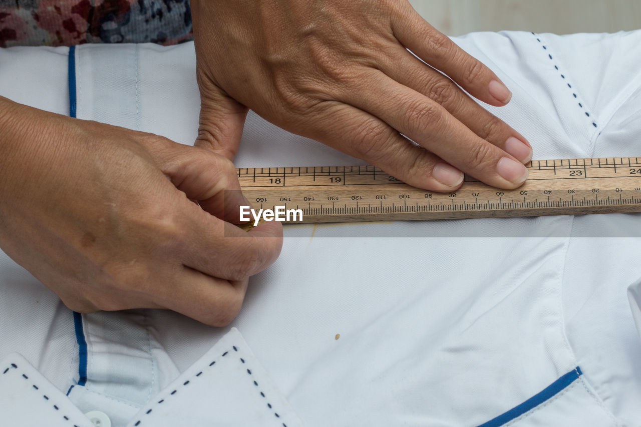 Midsection of tailor measuring textile