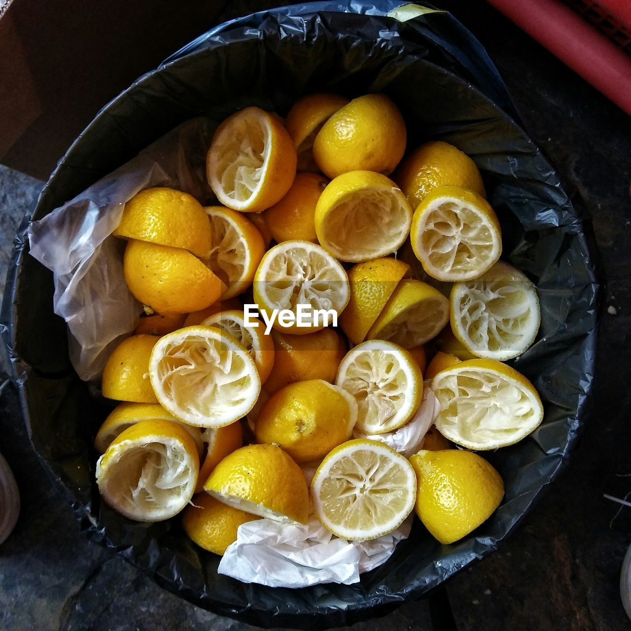 Directly above shot of sliced lemons in garbage bin