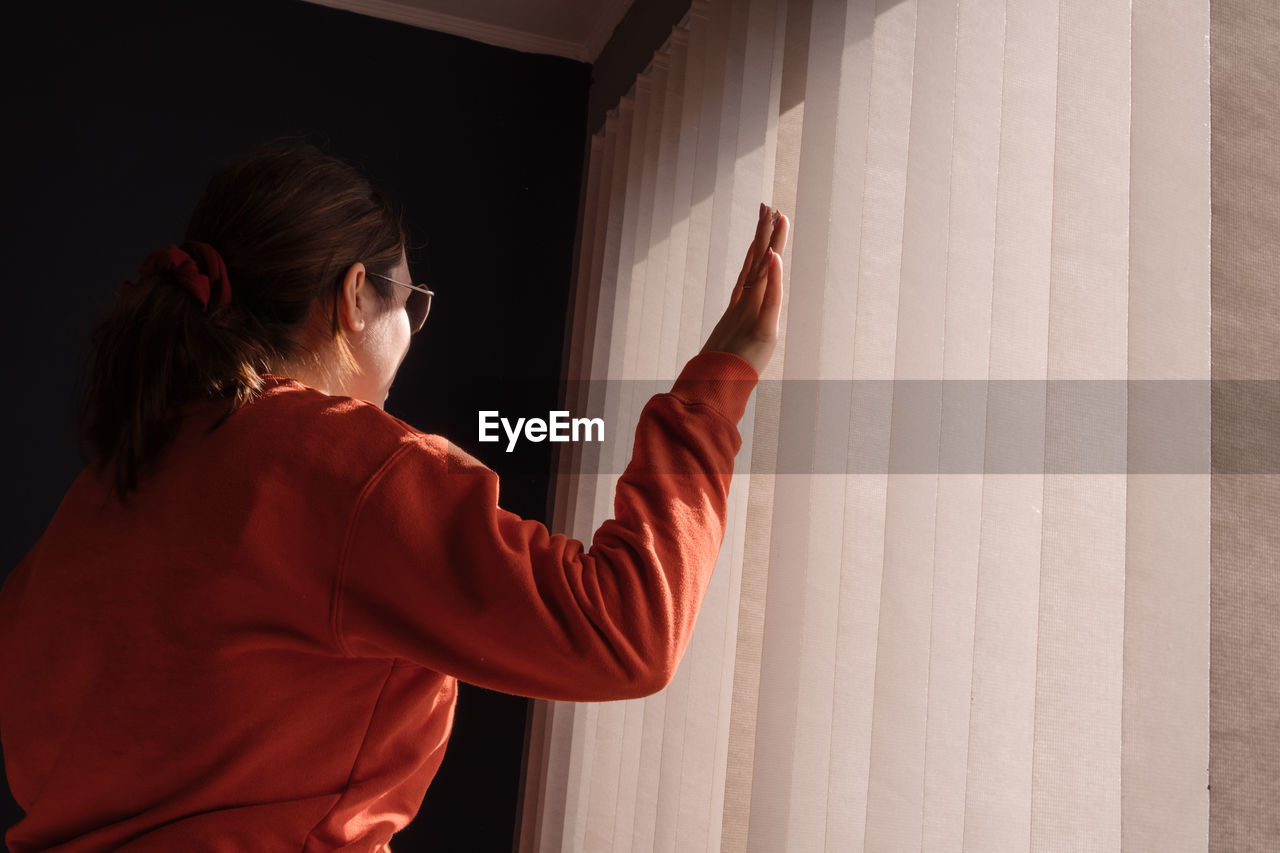 Woman in a room at home near window