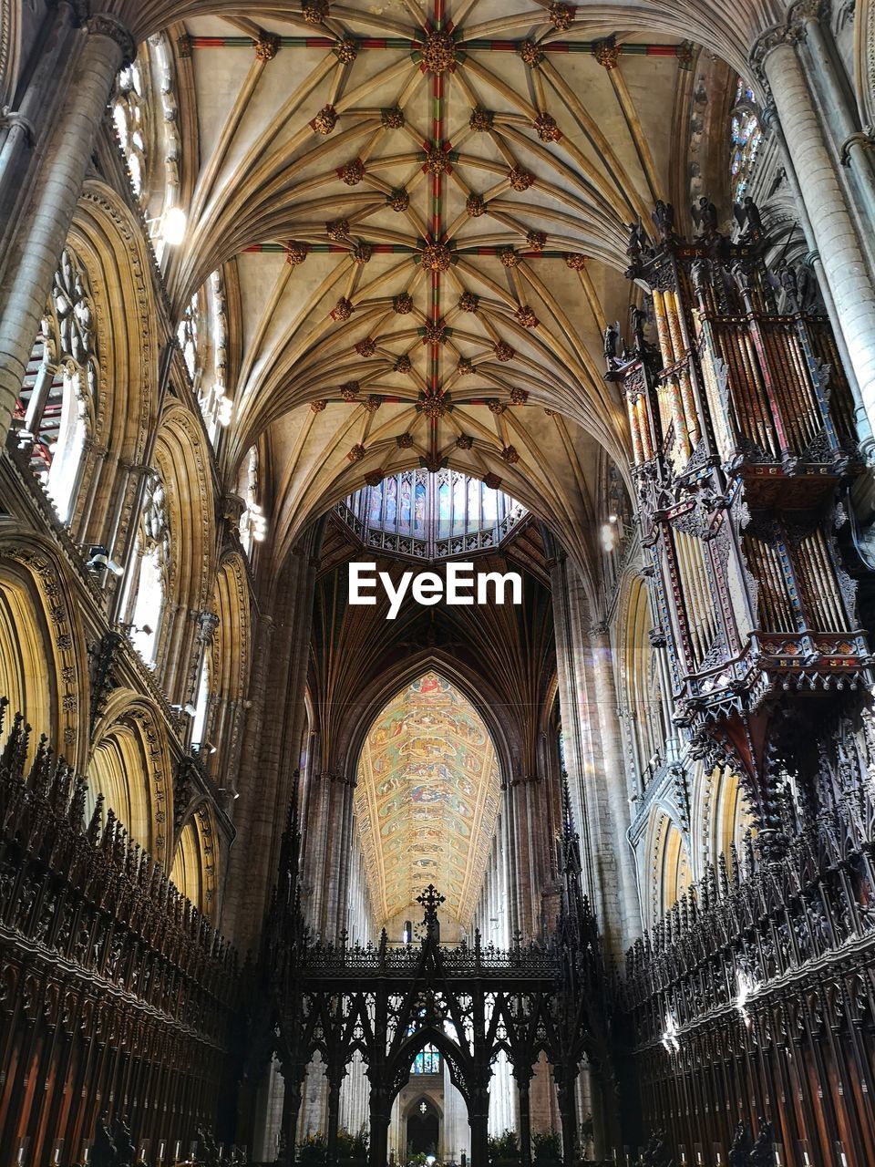 architecture, built structure, place of worship, arch, religion, belief, building, spirituality, ceiling, indoors, catholicism, worship, travel destinations, low angle view, the past, history, window, architectural column, glass, travel, no people, architectural feature, tourism, day, pipe organ, stained glass