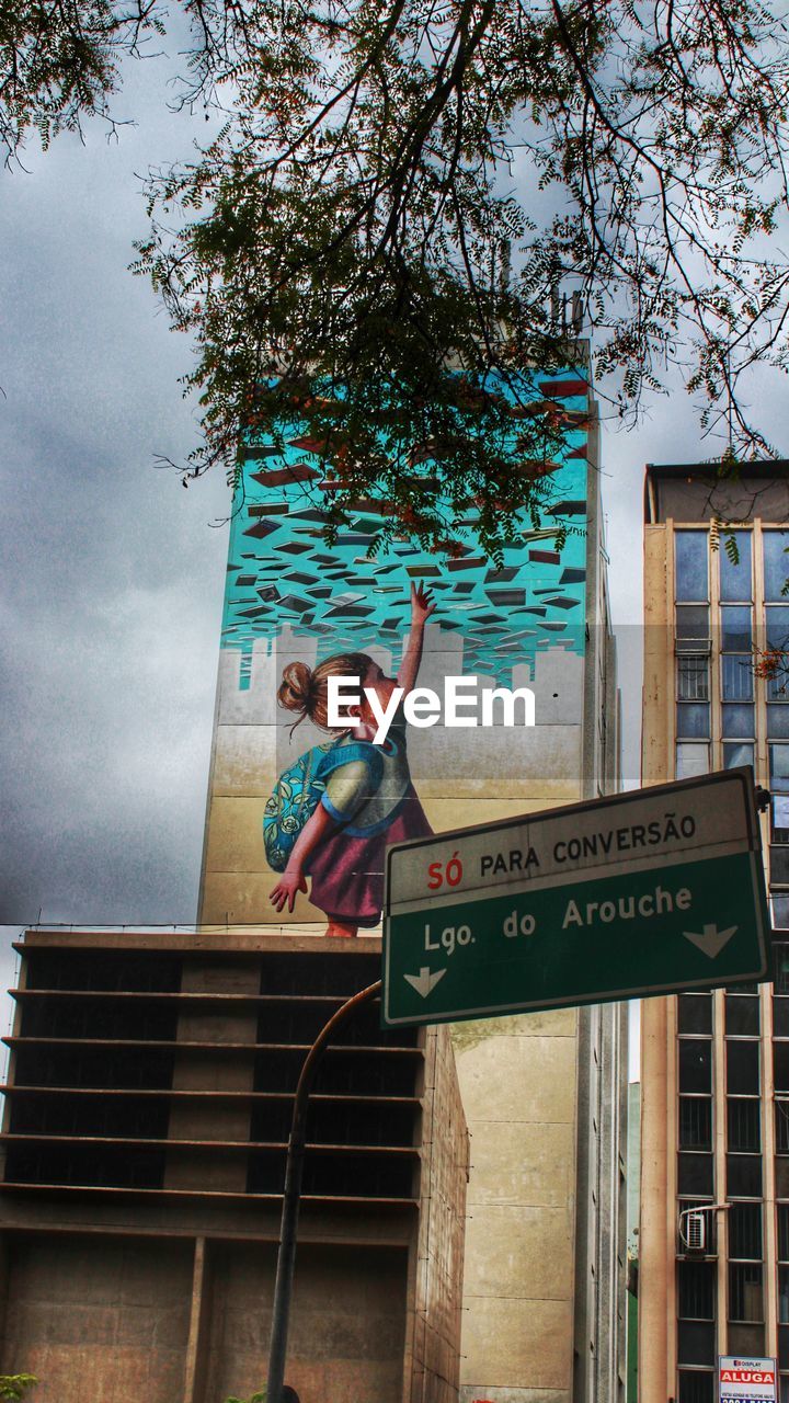 LOW ANGLE VIEW OF SIGNBOARD AGAINST SKY