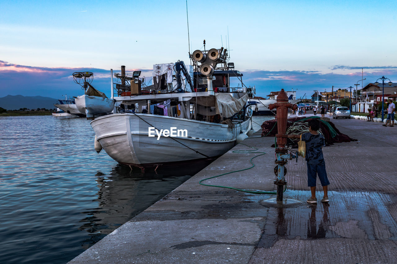 BOAT MOORED AT HARBOR