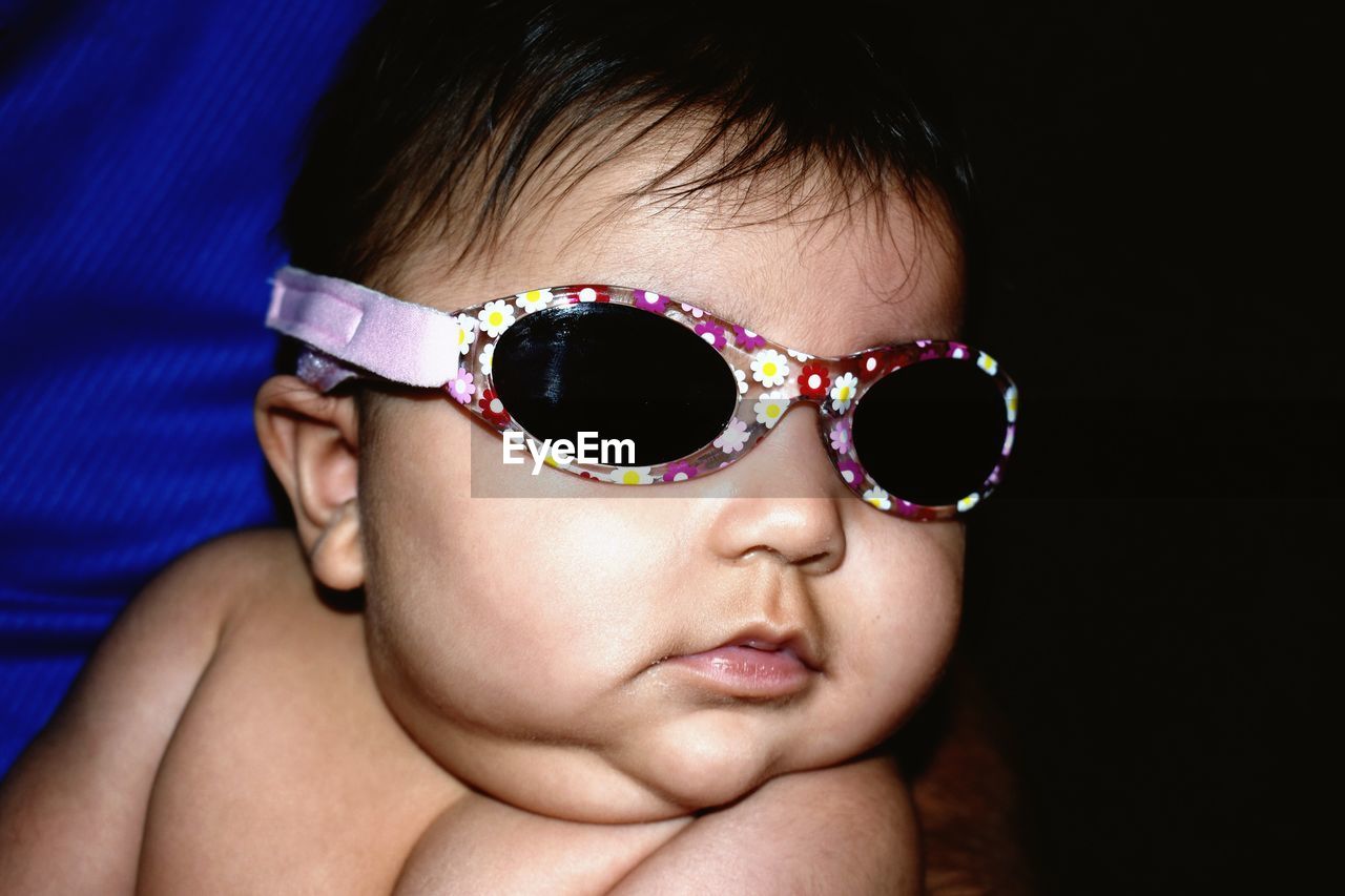 Close-up of baby girl wearing sunglasses