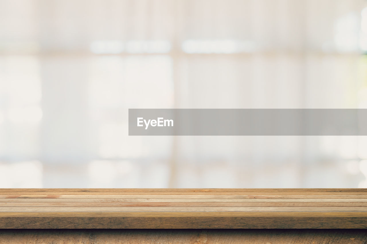 wood, indoors, floor, no people, focus on foreground, window covering, furniture, hardwood, interior design, window, flooring, molding, copy space, close-up, day, shelf, home interior, table, selective focus, wall, simplicity, room