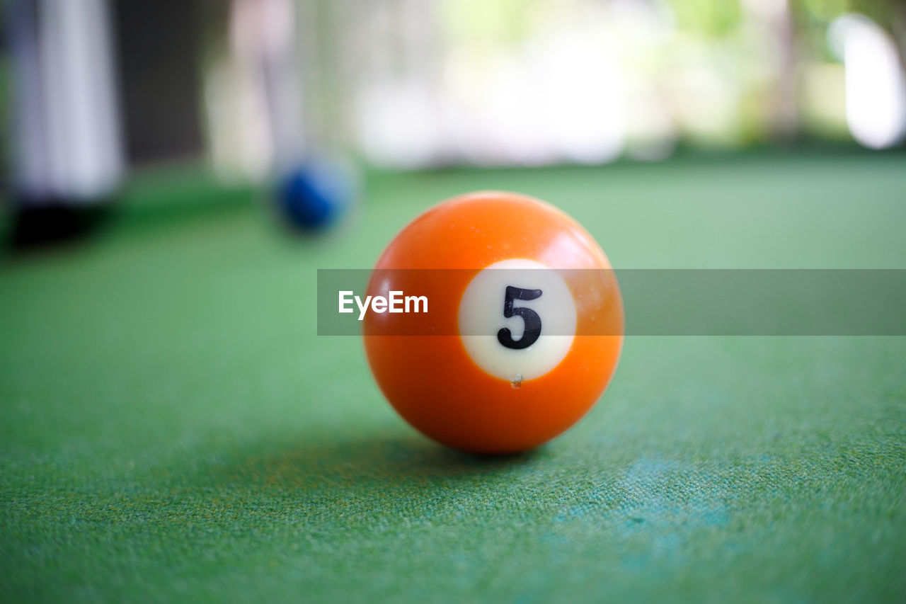 CLOSE-UP OF YELLOW BALL ON TABLE AT HOME