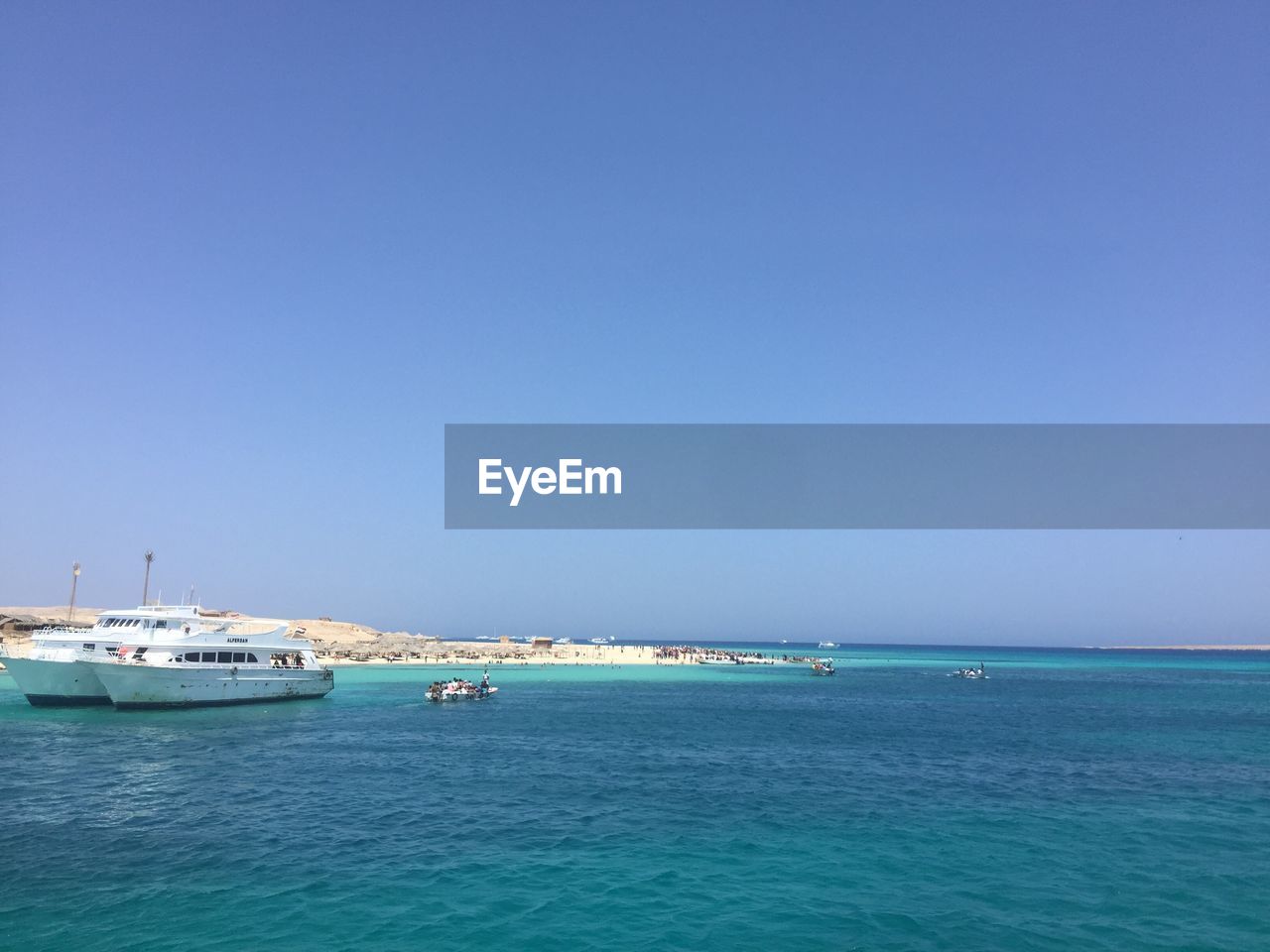 BOATS ON SEA AGAINST CLEAR BLUE SKY