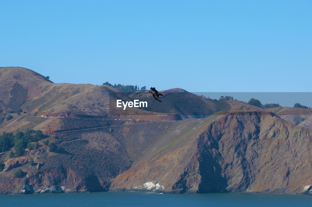 Scenic view of the columbia river and mountains against clear blue sky