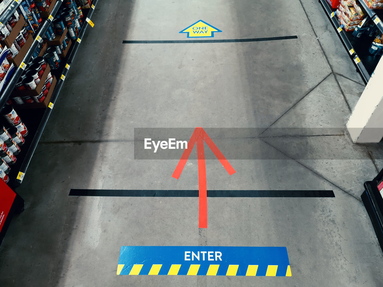 Tape lines on store floor for maintaining physical distancing.