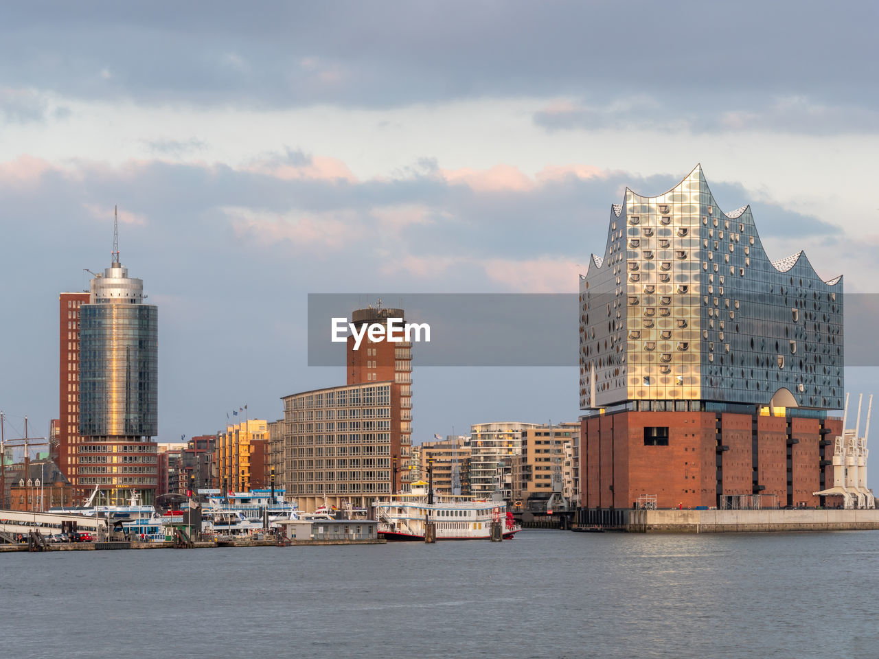 SEA BY BUILDINGS AGAINST SKY