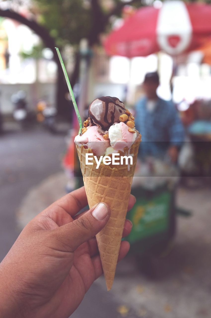 Cropped hand of woman holding ice cream cone