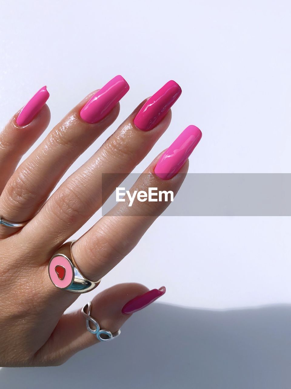 hand, nail, nail polish, pink, finger, fingernail, manicure, fashion, one person, women, adult, nail art, beauty treatment, nail care, close-up, studio shot, arts culture and entertainment, indoors, ring, cosmetics, jewelry, purple, lifestyles, red