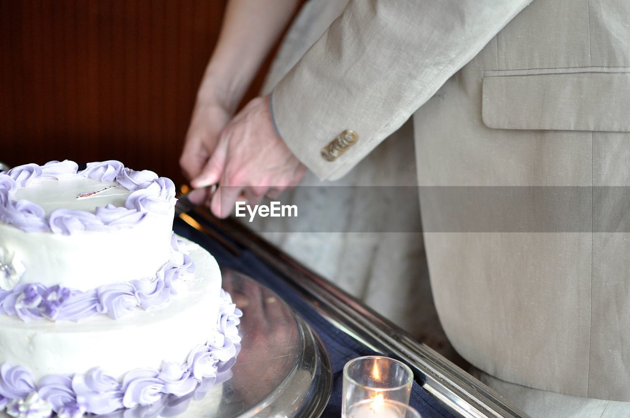 Couple cutting into wedding cake