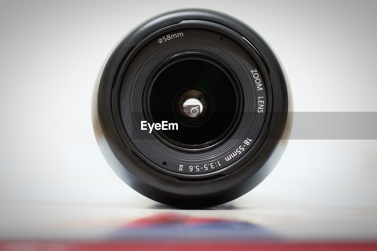 Close-up of camera lens against gray background