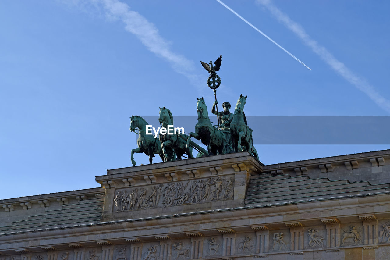 Low angle view of brandenburg gate against blue sky