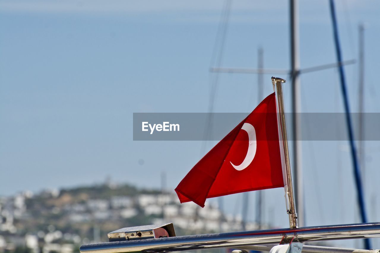 Close-up of turkish flag on railing against clear sky