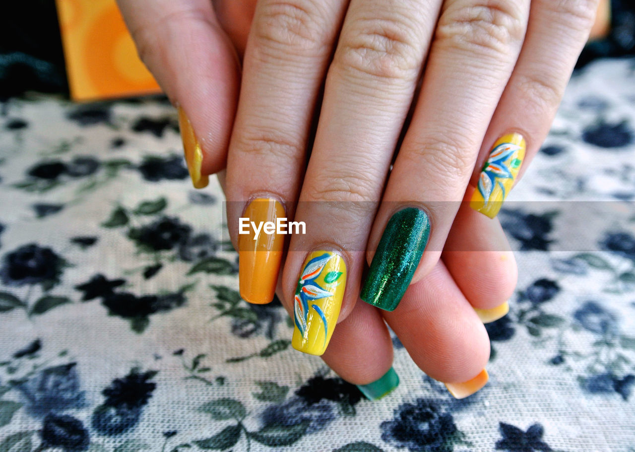 Close-up of woman fingers with colorful nail polish