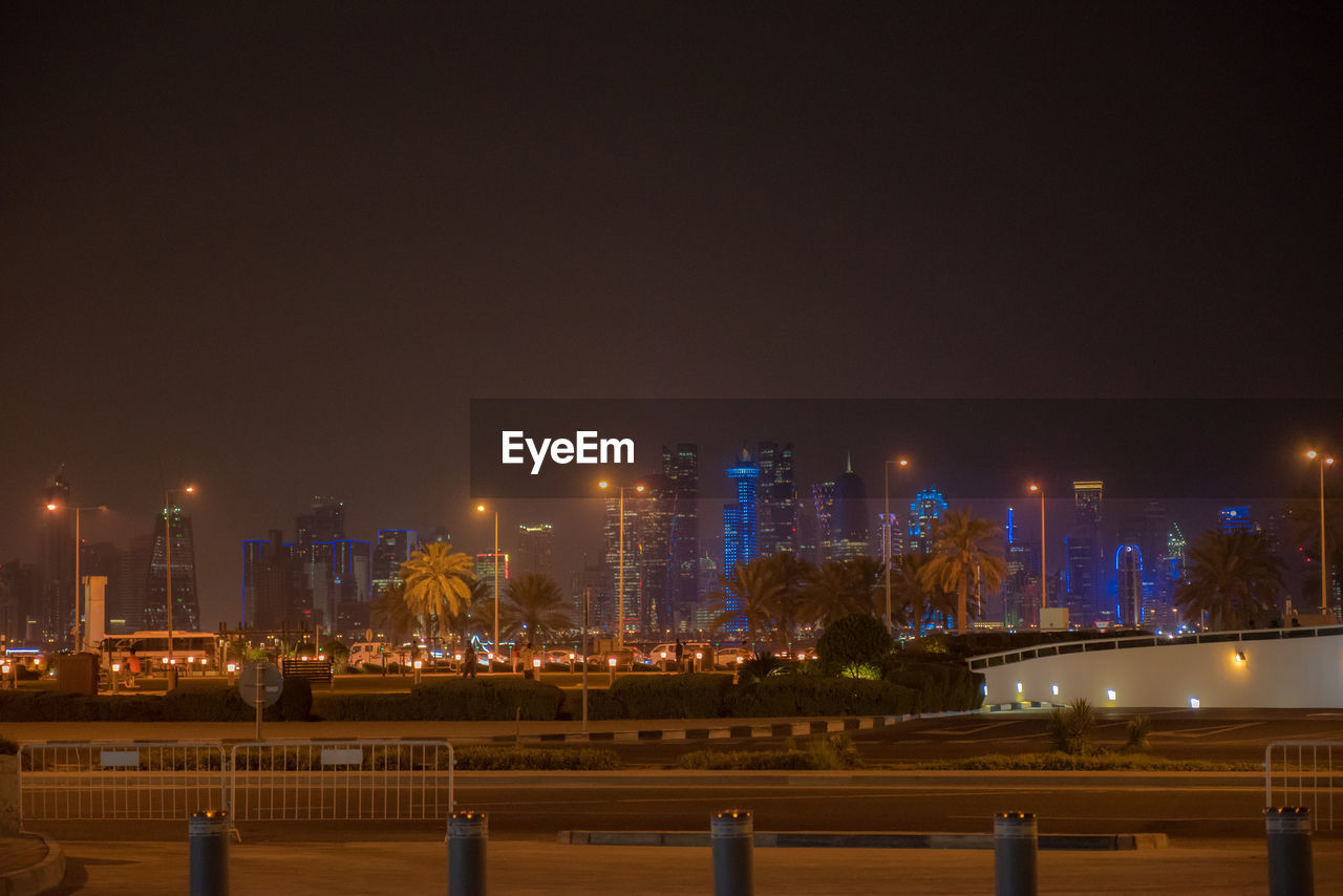 ILLUMINATED CITY BUILDINGS AT NIGHT