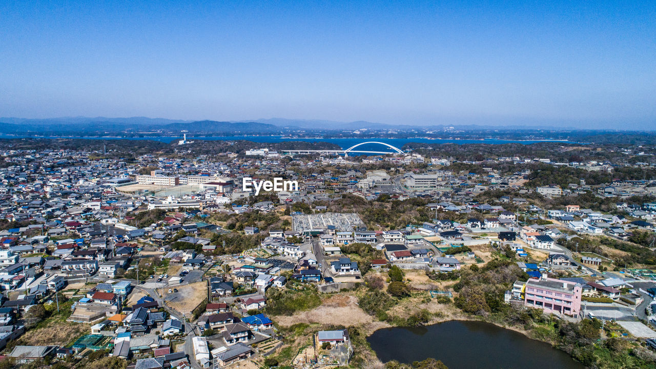 High angle view of townscape against blue sky