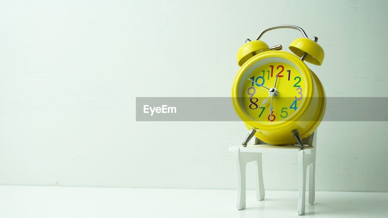 YELLOW CLOCK ON TABLE