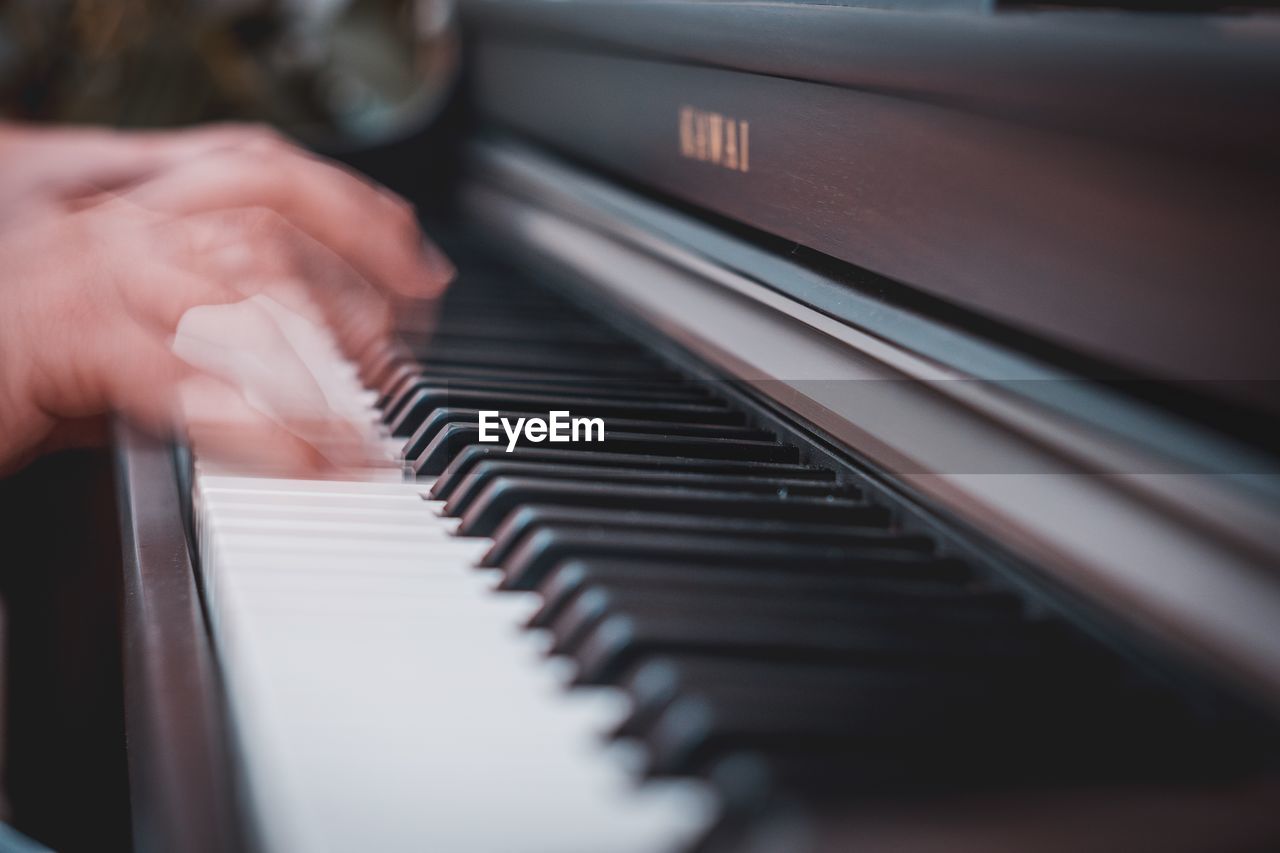 Blurred motion of hands playing piano