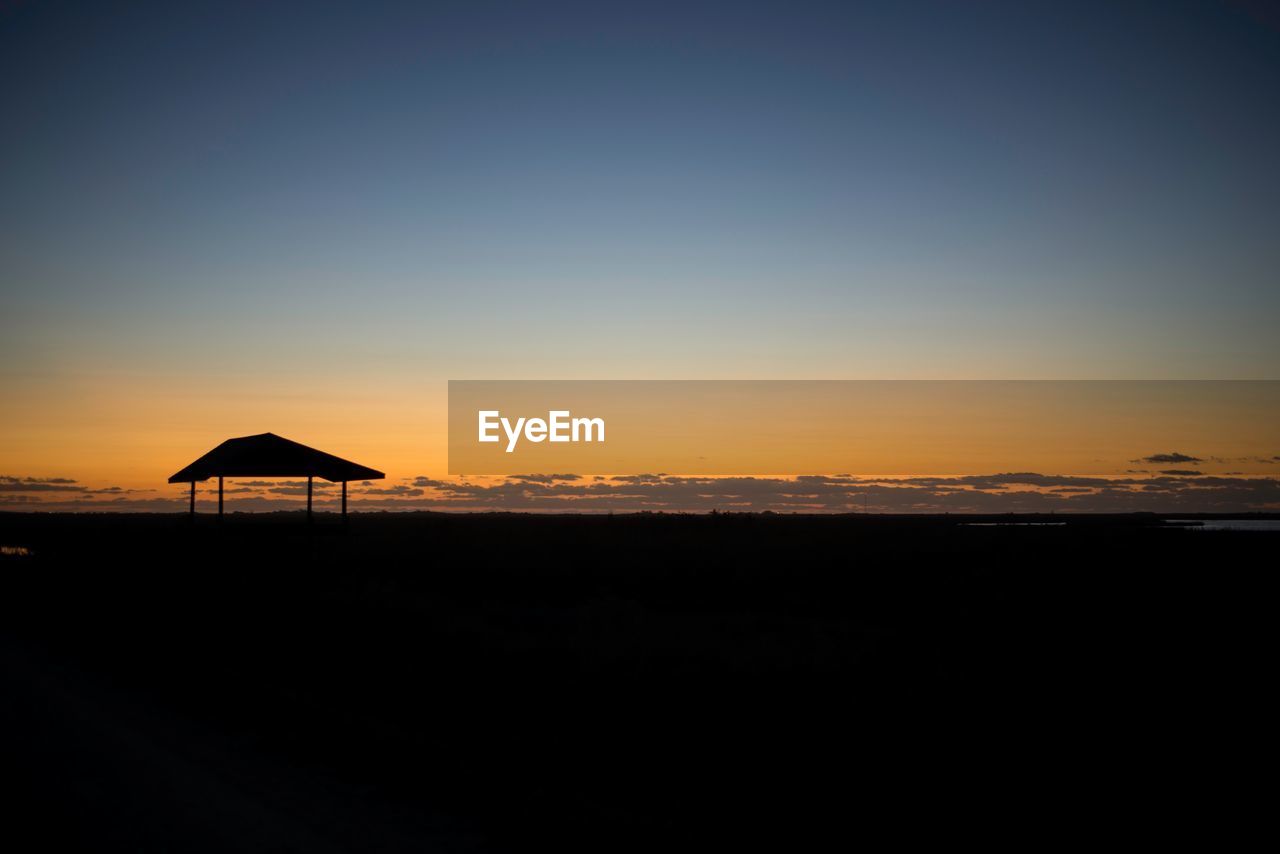 Scenic view of beach against sky during sunset