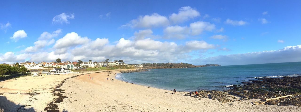 Scenic view of beach against cloudy sky