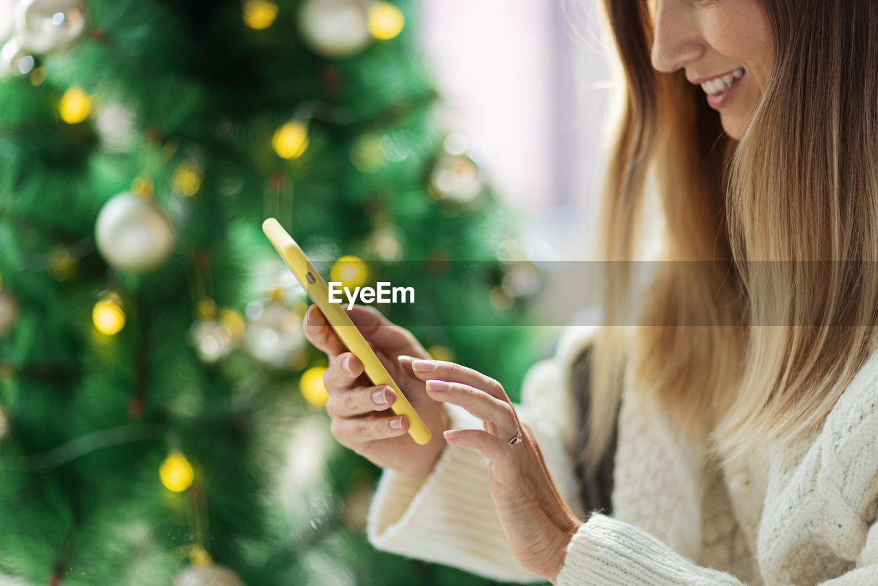 Close-up of woman holding christmas tree
